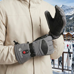 A Man Wearing A Pair Gray Rechargeable Heated Ski Gloves