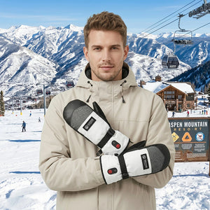 A young man wearing Savior Heat heated snow mittens at a ski resort