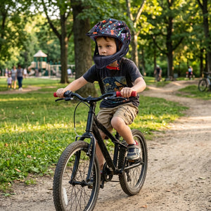 Young boy wearing full face helmets while riding bicycles